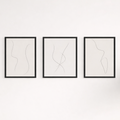 Three framed abstract line art pieces on a white wall