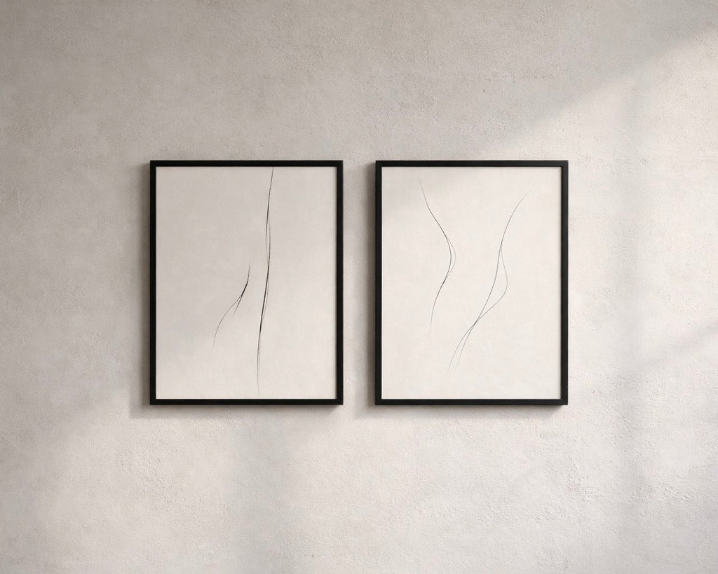 Two framed abstract artworks on a gray wall