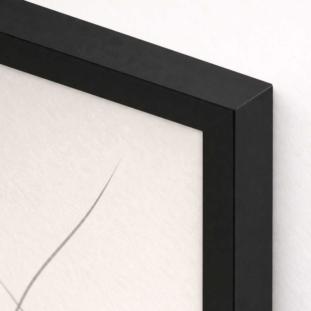 Close-up of a black framed artwork on a white background