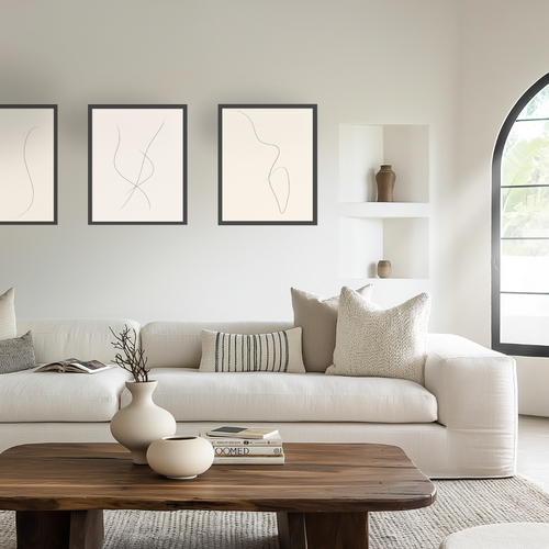 Modern living room with a white sofa, wooden coffee table, and abstract art on the wall.